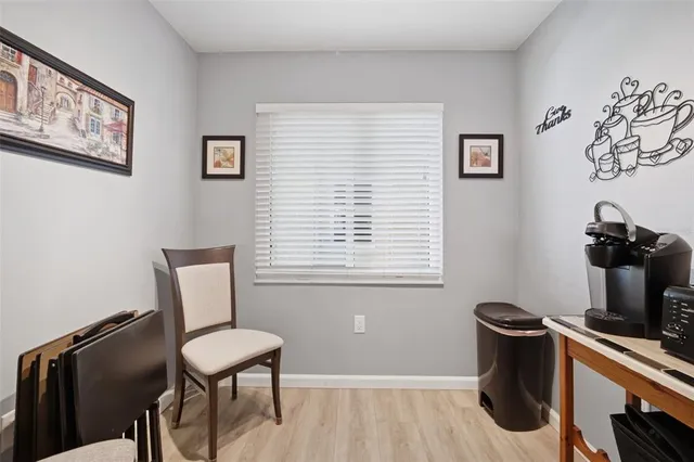 a view of a workspace with furniture and a window