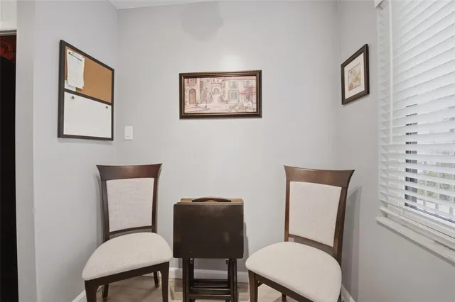 a blue chair sitting in a room next to a window
