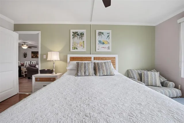 a bedroom with a large bed and a chandelier