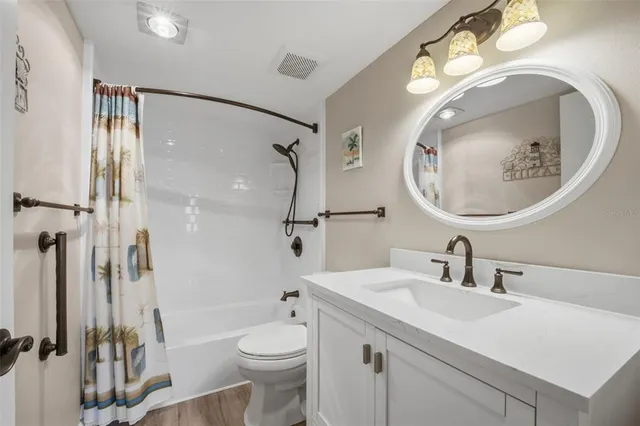 a bathroom with a toilet a sink and a mirror