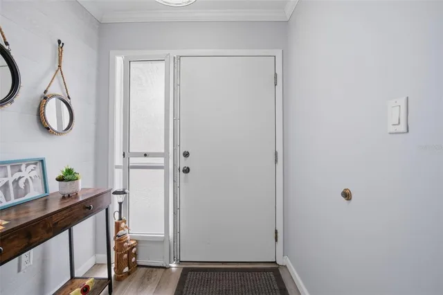 a view of an entryway with wooden floor