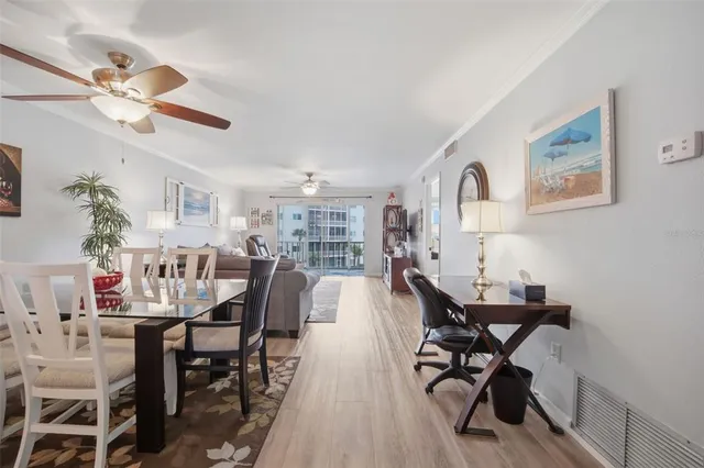 a view of a dining room with furniture and a chandelier