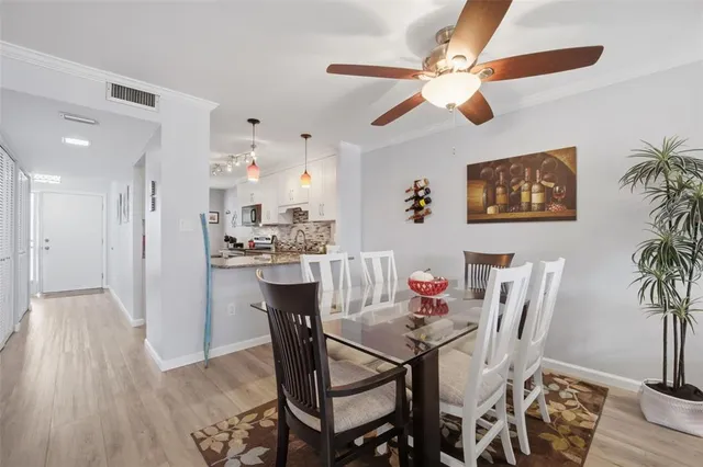 a view of a dining room with furniture and wooden floor