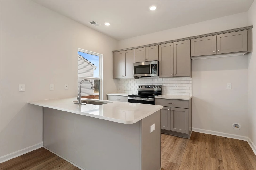 144 Cotesworth Street Pendleton, SC 29670 - Photo 3 of 9 This kitchen features sleek countertops, modern appliances, and a bright, functional design.