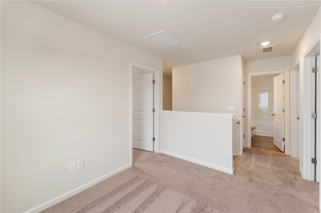 144 Cotesworth Street Pendleton, SC 29670 - Photo 4 of 9 This versatile upper-level landing provides flexible space, ideal for various uses, connecting multiple rooms.