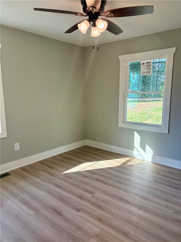 351 Randys Road Westminster, SC 29693 - Photo 22 of 30 A well-lit room showcasing a ceiling fan and durable flooring, perfect for a peaceful retreat.