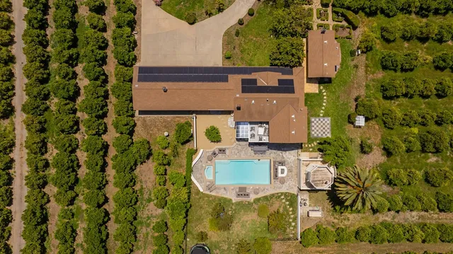 an aerial view of a house with a yard