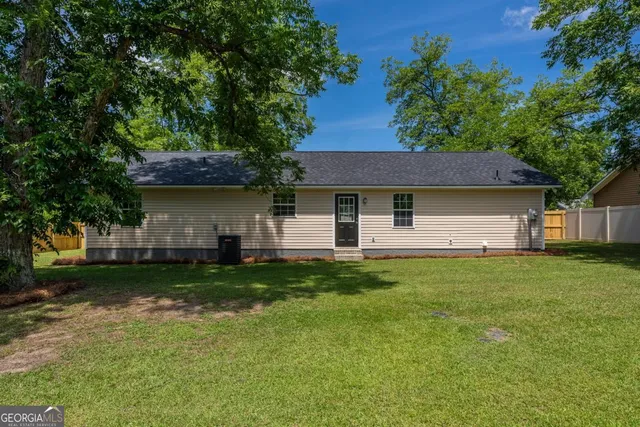 a yellow house with swimming pool in front of it