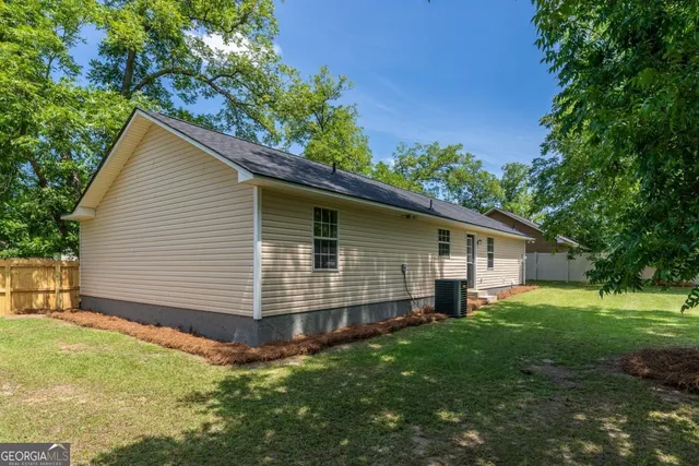 a yellow house in middle of the forest