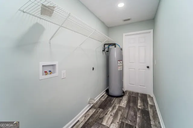 an empty room with a ceiling fan and a window