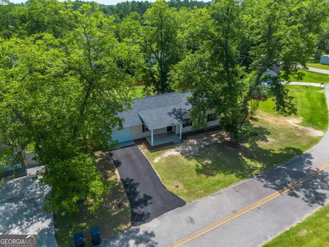 an aerial view of a house with a yard