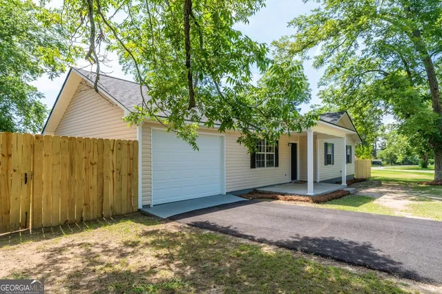 a view of house with backyard