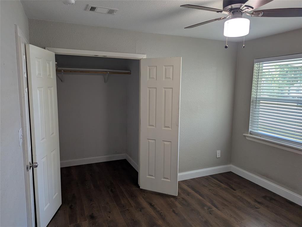 100 West Hull Street Denison, TX 75021 - Photo 12 of 28 an empty room with wooden floor fan and windows