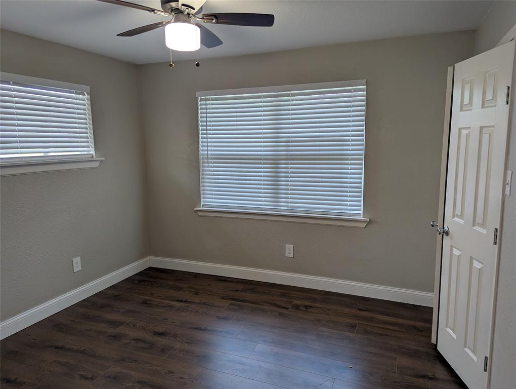 100 West Hull Street Denison, TX 75021 - Photo 13 of 28 a view of an empty room with wooden floor and a window