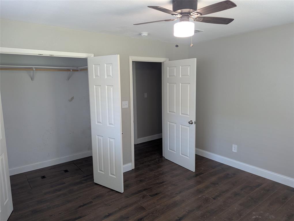 100 West Hull Street Denison, TX 75021 - Photo 16 of 28 an empty room with wooden floor a ceiling fan and closet