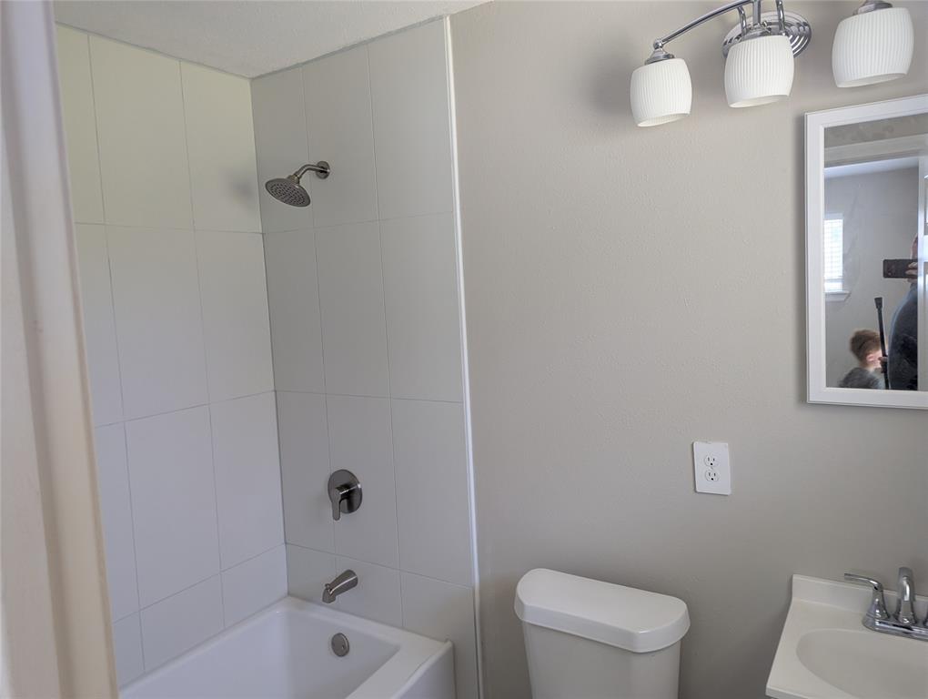 100 West Hull Street Denison, TX 75021 - Photo 17 of 28 a bathroom with a bathtub and sink