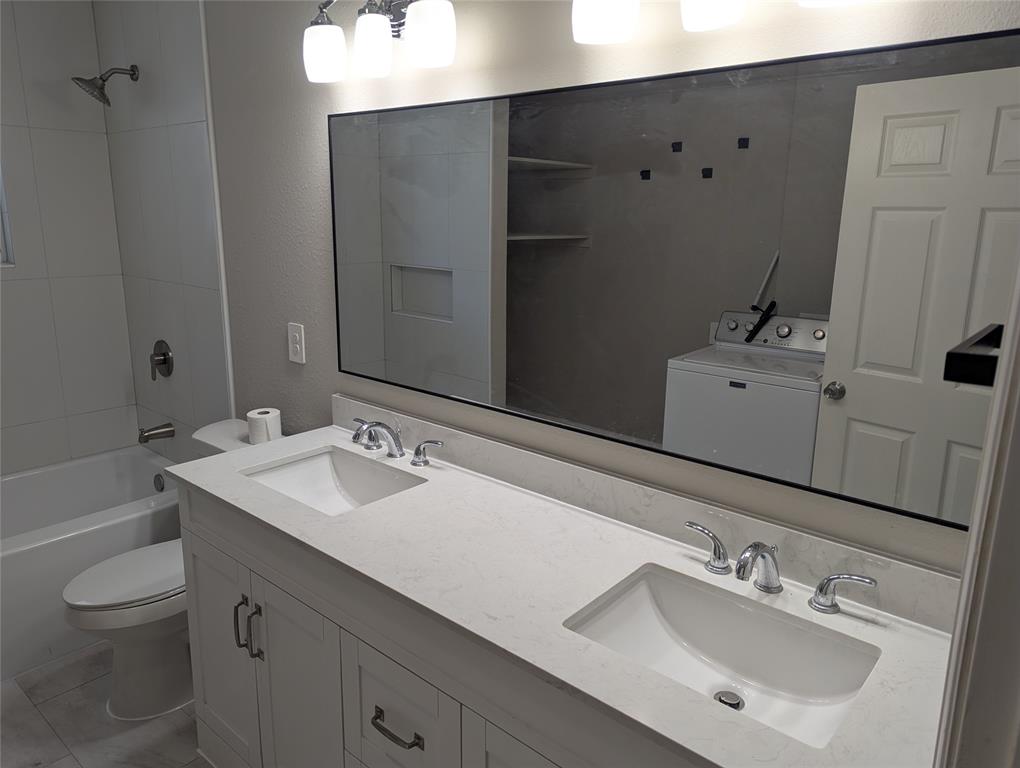 100 West Hull Street Denison, TX 75021 - Photo 19 of 28 a bathroom with a sink and a mirror
