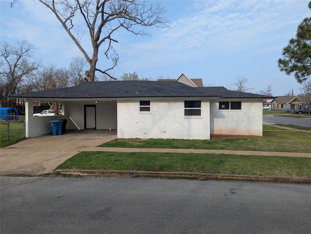 100 West Hull Street Denison, TX 75021 - Photo 3 of 28 a front view of a house with a garden and yard