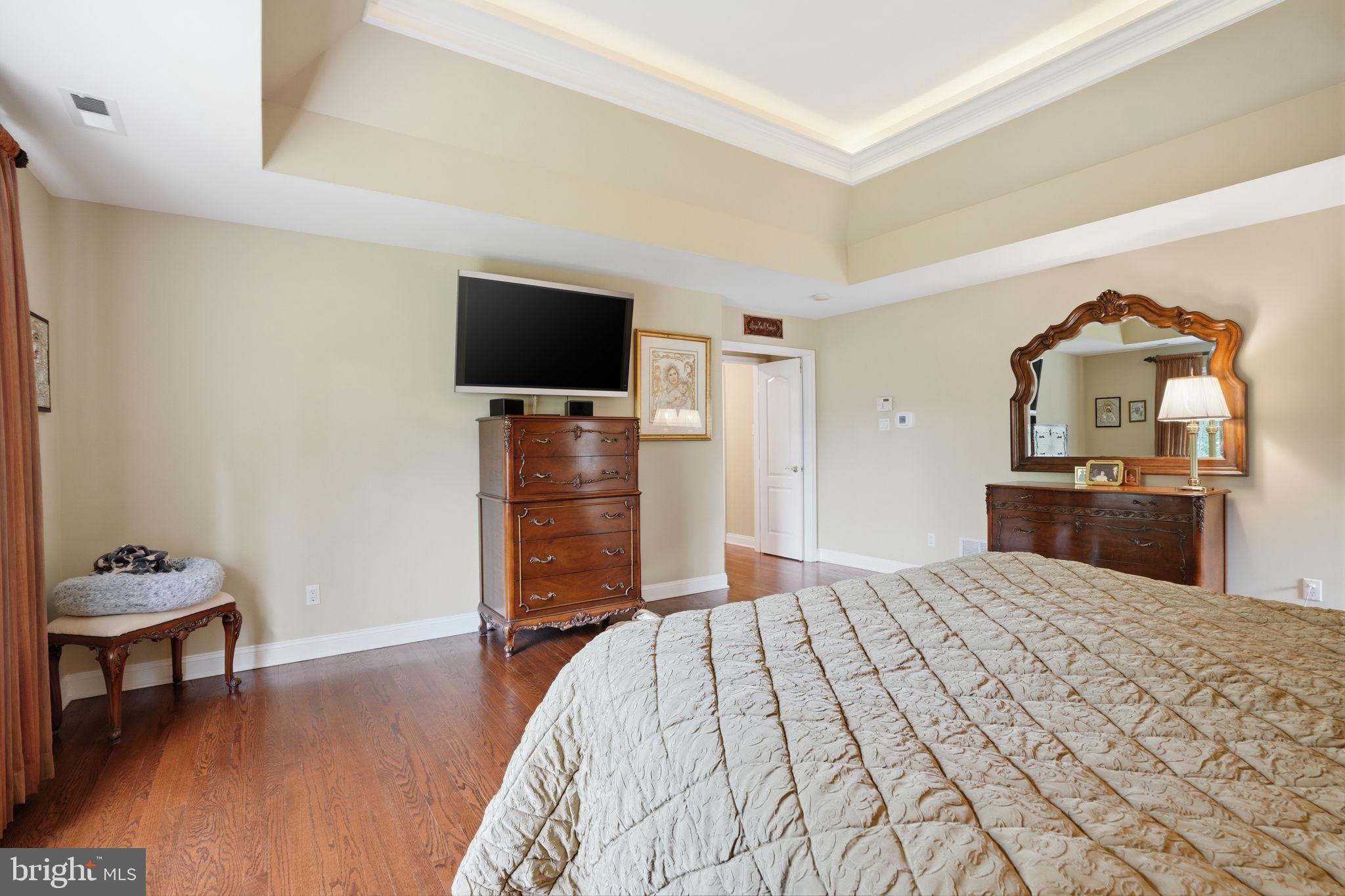 1588 Wrightstown Road Newtown, PA 18940 - Photo 52 of 81 a bedroom with a bed and a flat screen tv