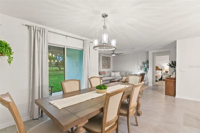 a living room with furniture and a ceiling fan