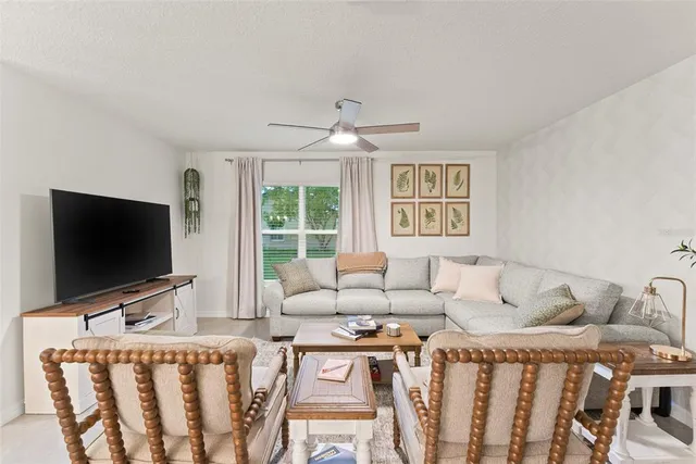 a hallway with a table and a refrigerator