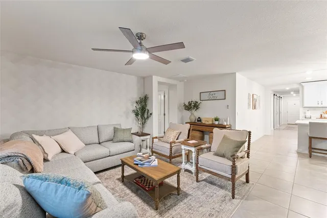 a living room with furniture and flat screen tv