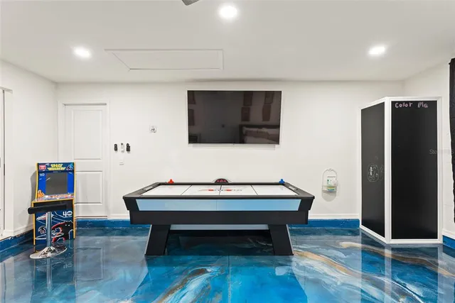 a bedroom with a large bed and a ceiling fan