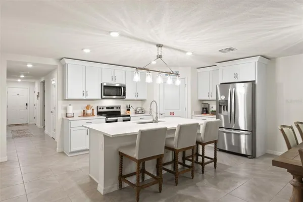 a kitchen with stainless steel appliances granite countertop a sink stove and microwave
