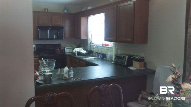 8877 Fall Court Mobile, AL 36695 - Photo 12 of 27 Kitchen from great room. This kitchen boasts open views to the great room. There is a breakfast bar for additional dining.