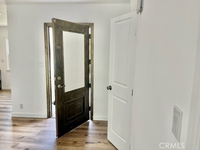 19550 Vanowen Street Reseda, CA 91335 - Photo 3 of 10 a view of a hallway with wooden floor and staircase