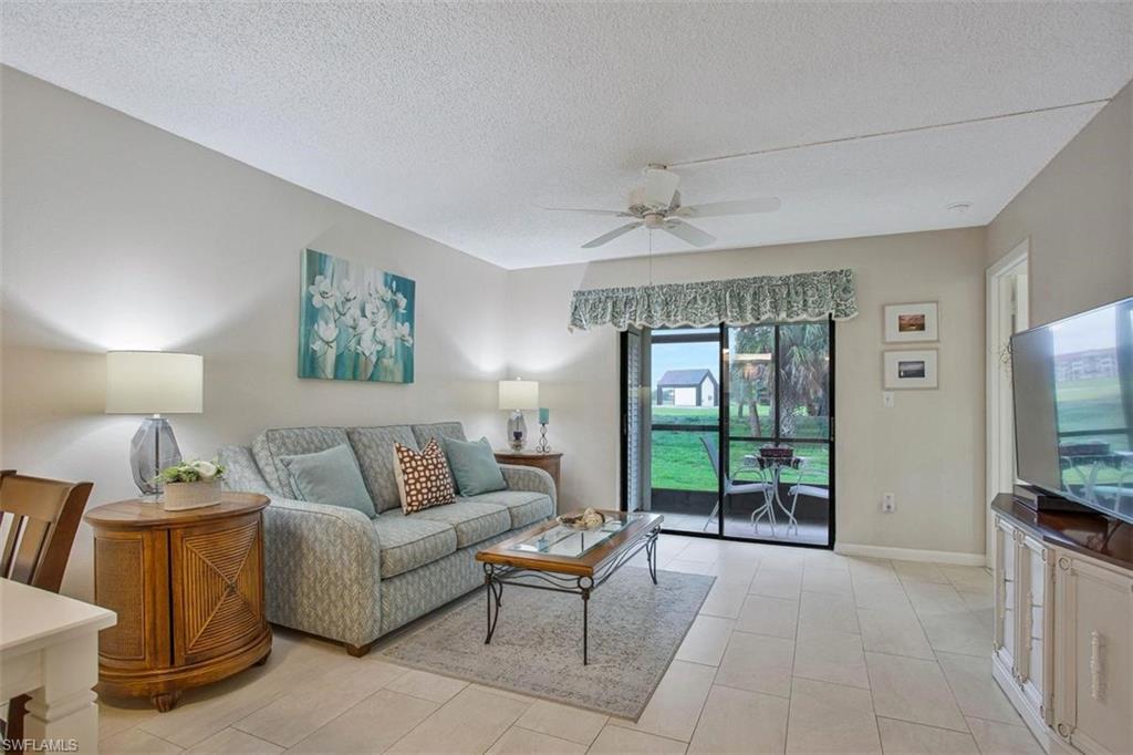 4258 27th Court Southwest, Unit 106 Naples, FL 34116 - Photo 13 of 19 Comfy living room space with view to the outdoors