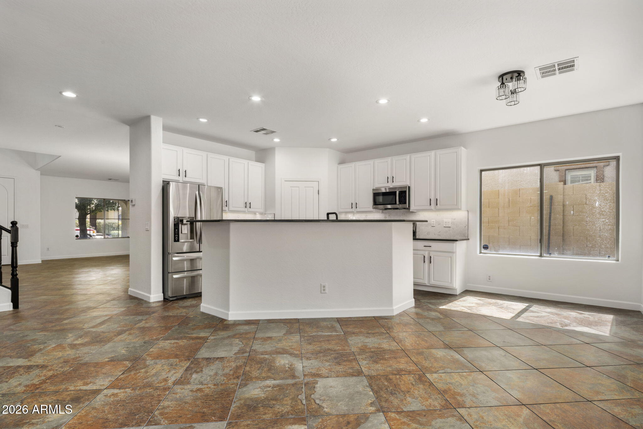 5121 West Beverly Road Laveen, AZ 85339 - Photo 16 of 32 a kitchen with stainless steel appliances a refrigerator and a stove top oven