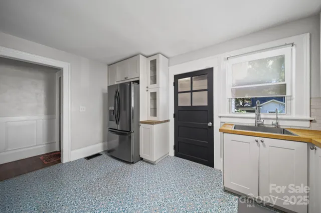 a kitchen with a refrigerator and a sink
