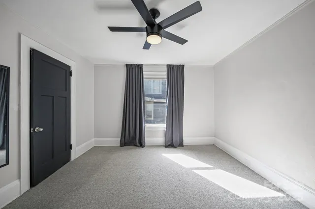 an empty room with closet and windows