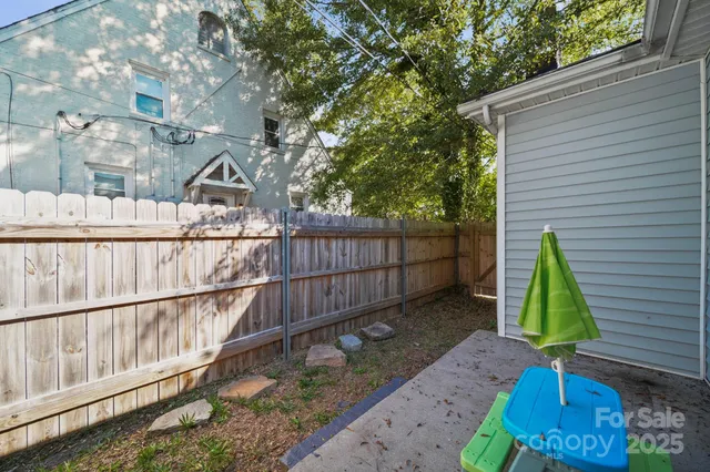 a view of a backyard with a iron fence