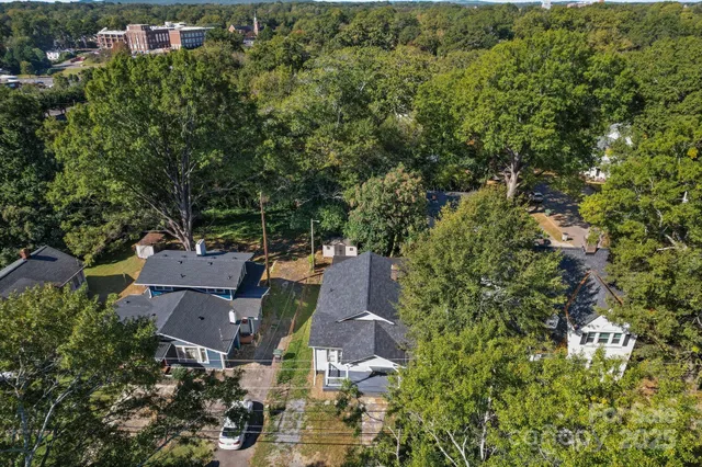 an aerial view of a house with a yard and outdoor seating