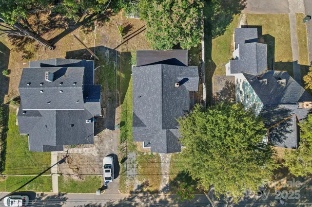 an aerial view of a house with a yard