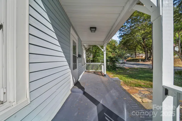 a view of a balcony with floor to ceiling windows with wooden floor