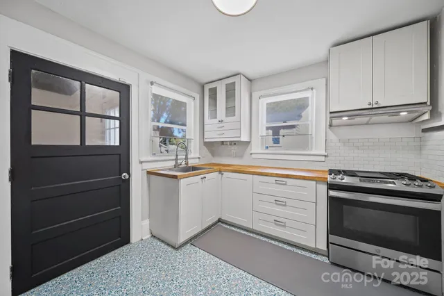a kitchen with granite countertop cabinets and window