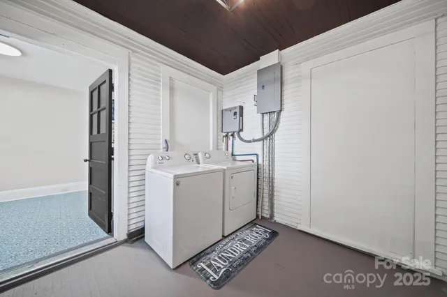 a utility room with cabinets washer and dryer