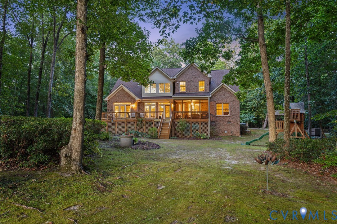 720 Arlington Island Road Lanexa, VA 23089 - Photo 11 of 50 Back of property at dusk with stairway, a yard, a