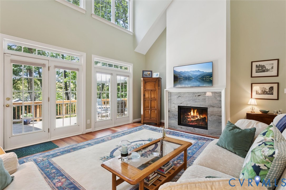 720 Arlington Island Road Lanexa, VA 23089 - Photo 18 of 50 Living room featuring a towering ceiling, a high e