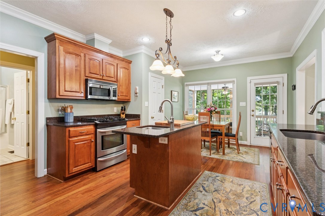 720 Arlington Island Road Lanexa, VA 23089 - Photo 21 of 50 Kitchen featuring brown cabinetry, dark wood-style