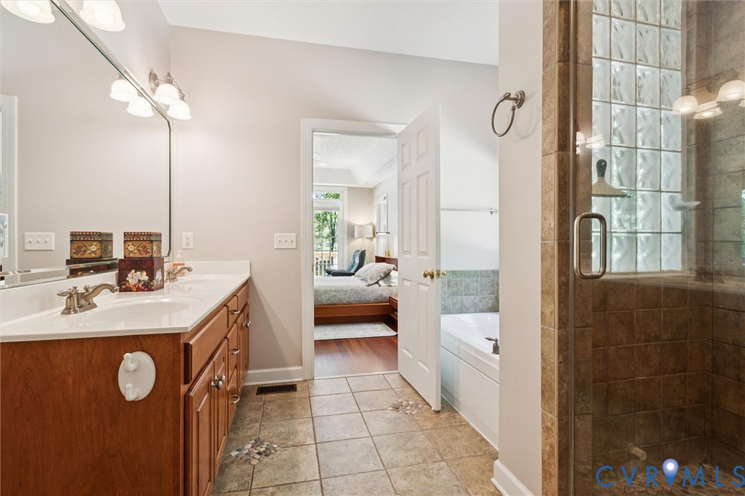 720 Arlington Island Road Lanexa, VA 23089 - Photo 31 of 50 Ensuite bathroom featuring double vanity, a garden