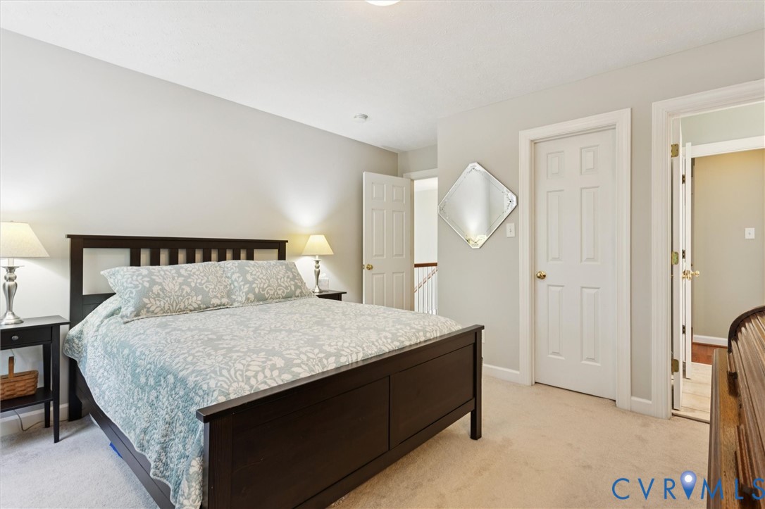 720 Arlington Island Road Lanexa, VA 23089 - Photo 37 of 50 Bedroom with light colored carpet and baseboards