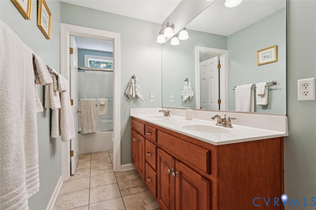 720 Arlington Island Road Lanexa, VA 23089 - Photo 38 of 50 Bathroom featuring double vanity, light tile patte