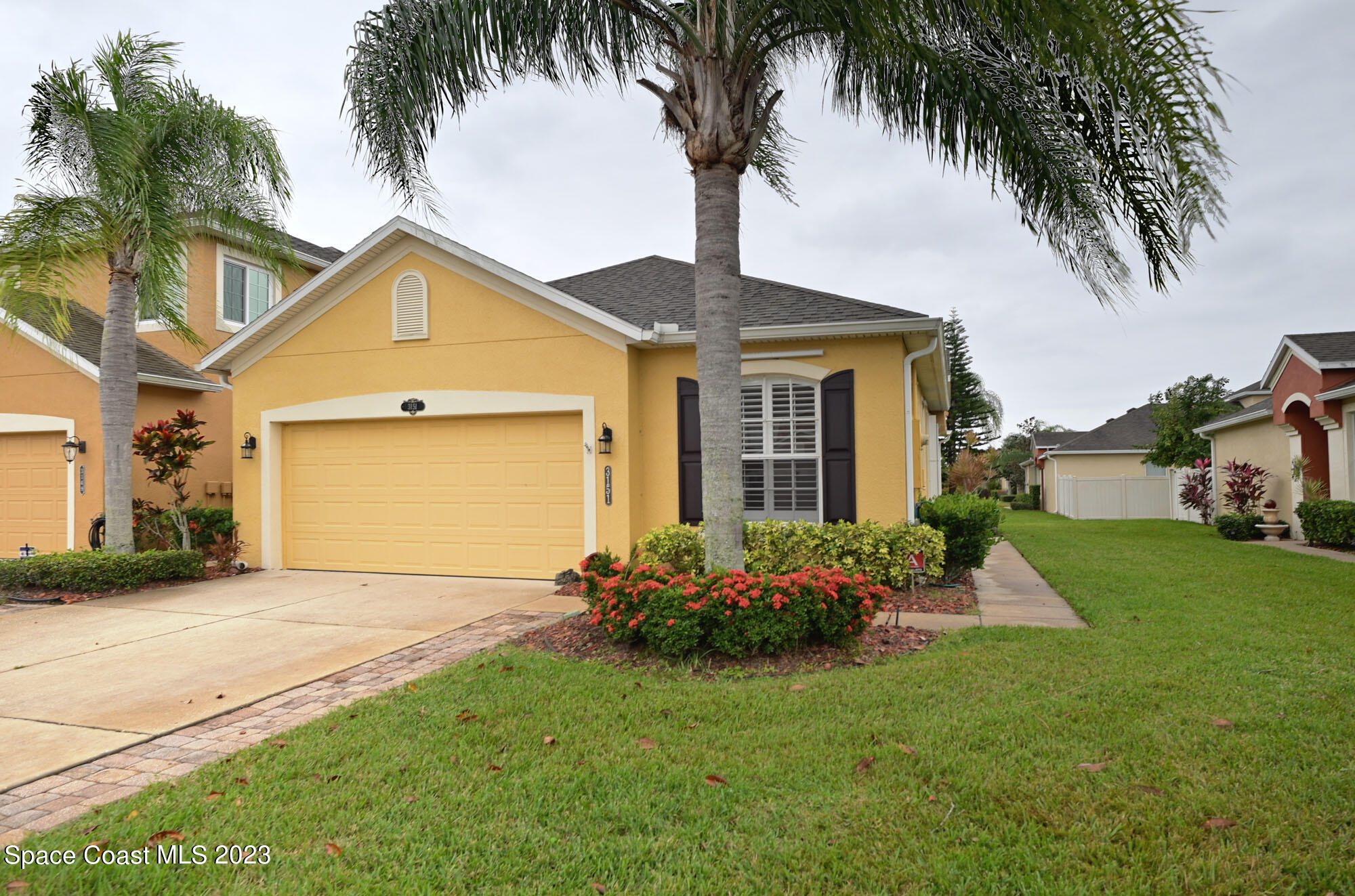 3151 Arden Circle Melbourne, FL 32934 - Photo 1 of 32 a front view of a house with a garden and yard