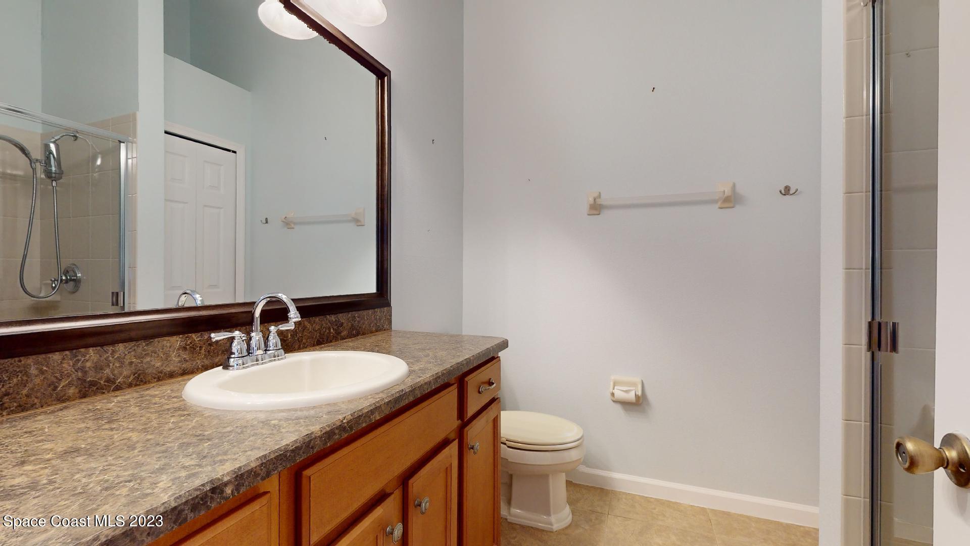 3151 Arden Circle Melbourne, FL 32934 - Photo 23 of 32 a bathroom with a granite countertop sink toilet and shower