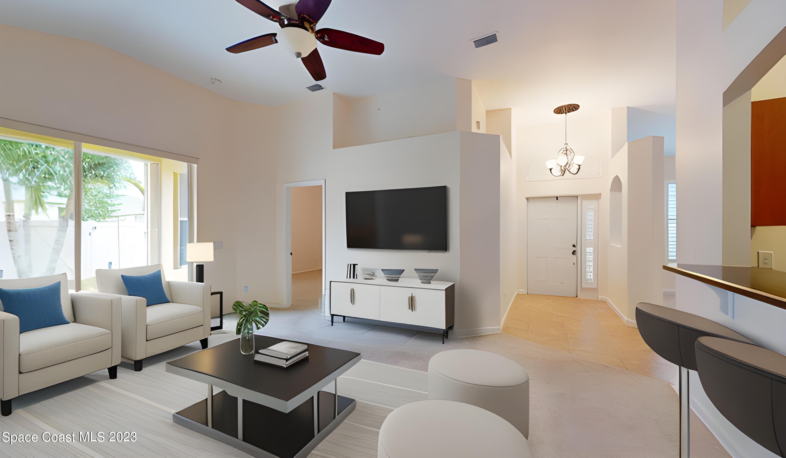 3151 Arden Circle Melbourne, FL 32934 - Photo 6 of 32 a living room with furniture a flat screen tv and a large window