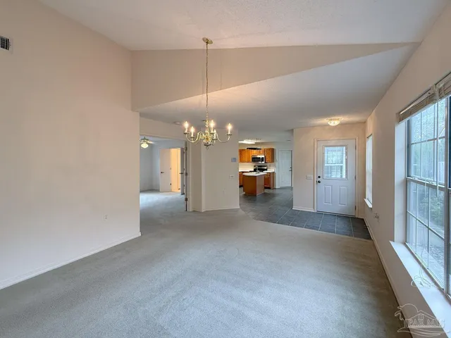a view of an empty room with a fireplace